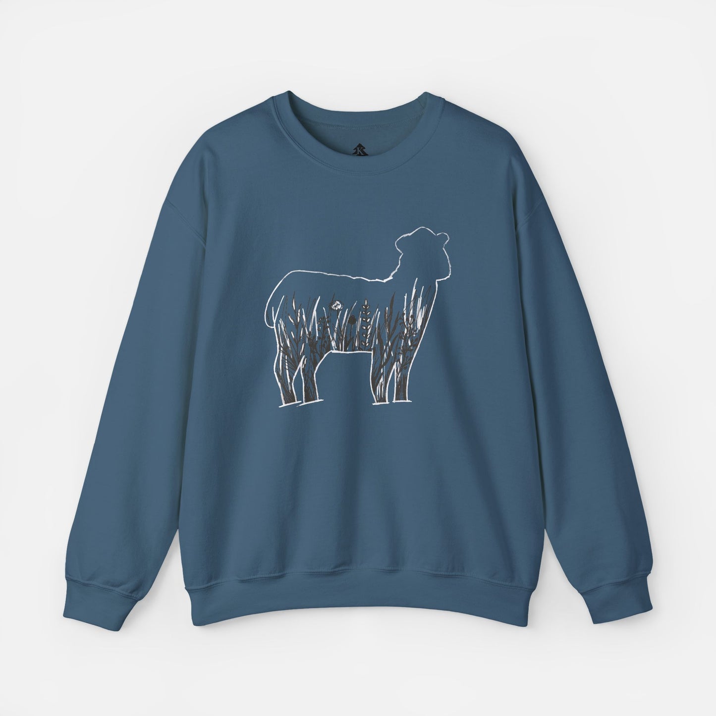 Flat lay of Wildflower Sheep blue sweatshirt on white background showing rustic floral sheep silhouette design centered on front.