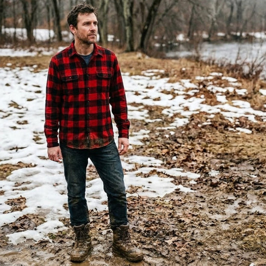 Classic Red Vermont Flannel shirt worn by a model navigating a muddy trail in Putnam, CT during New England Mud Season - Kempain Family Outfitters original field photo