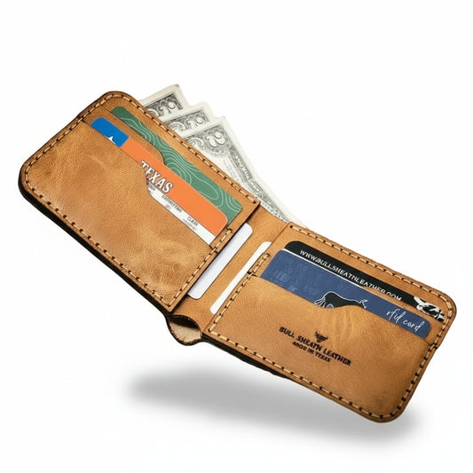 Brown leather wallet with cards and money on a wooden surface
