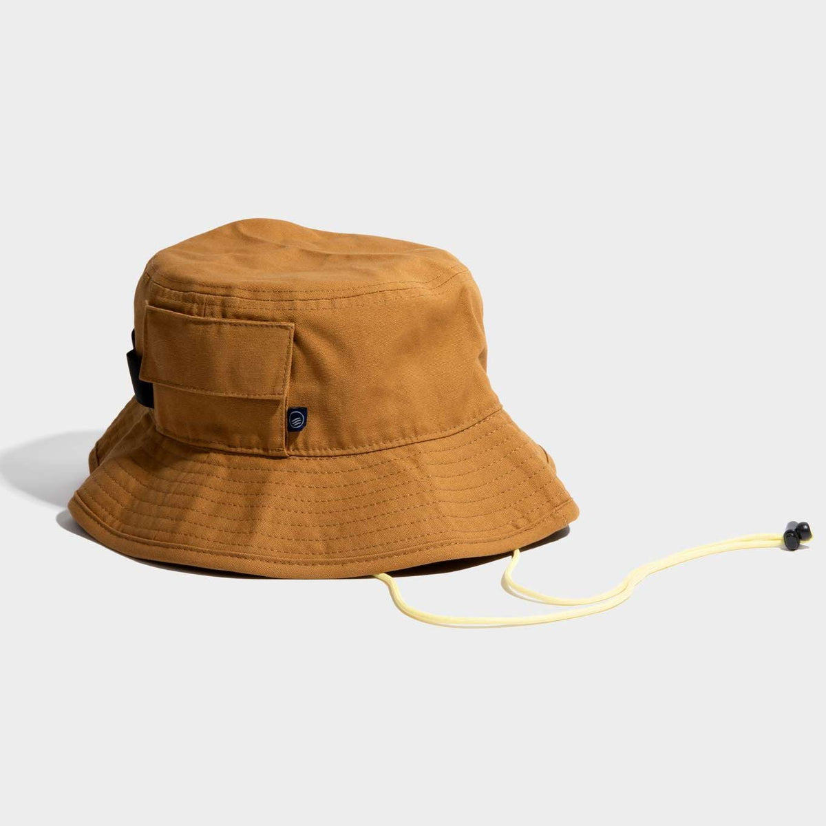 A brown honey color 100% Organic Cotton Utility Bucket Hat by United By Blue displayed on a white background.