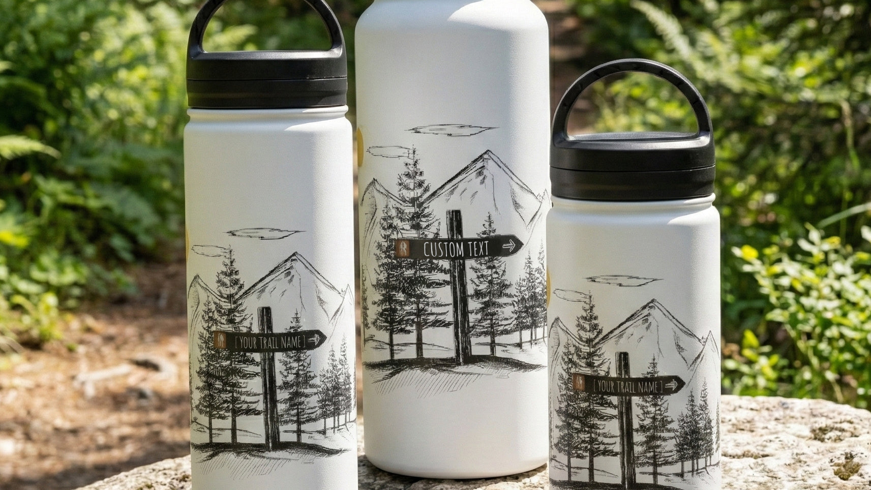 Three insulated water bottles with custom hiking sign post designs on a forest background by Kempain Family Outfitters.