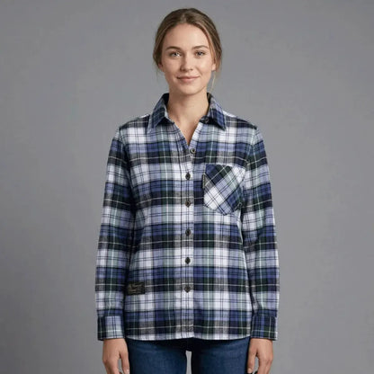 Woman wearing a blue and green plaid shirt by Vermont Flannel Company on a gray background.