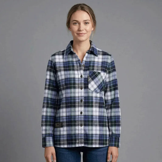Woman wearing a blue and green plaid shirt by Vermont Flannel Company on a gray background.