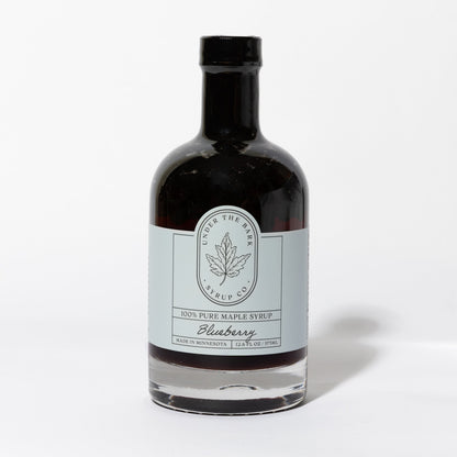 12.6 FL OZ Bottle of blueberry infused 100% pure maple syrup by Under The Bark Syrup Co. on a white background.