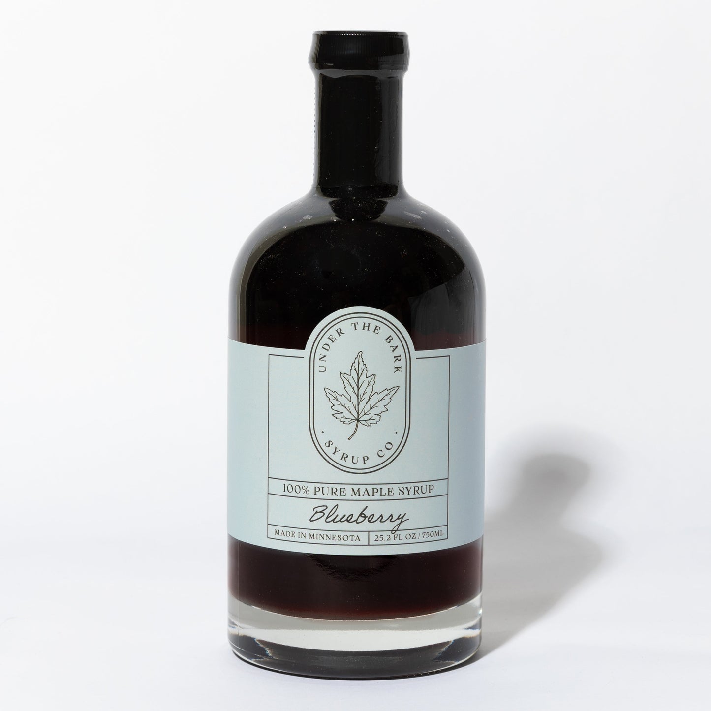 25.2 FL OZ Bottle of blueberry infused 100% pure maple syrup by Under The Bark Syrup Co. on a white background.