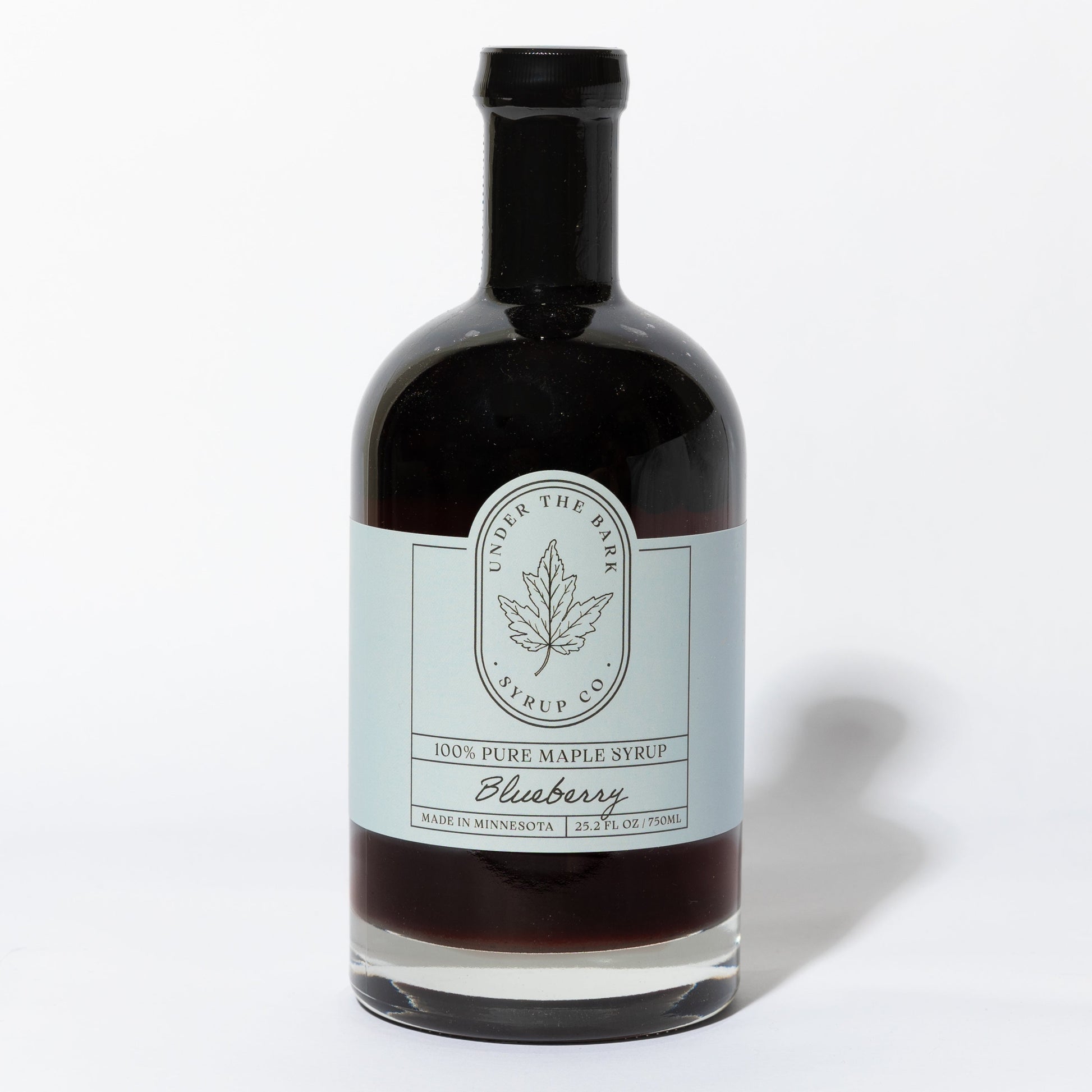 25.2 FL OZ Bottle of blueberry infused 100% pure maple syrup by Under The Bark Syrup Co. on a white background.