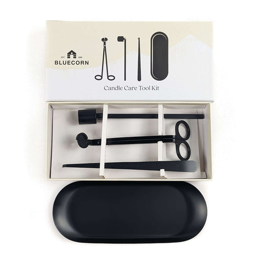 Bluecorn Candle Care Tool Kit shown open with its box lid above, containing black metal tools, with a black oval case placed in front on a white background.