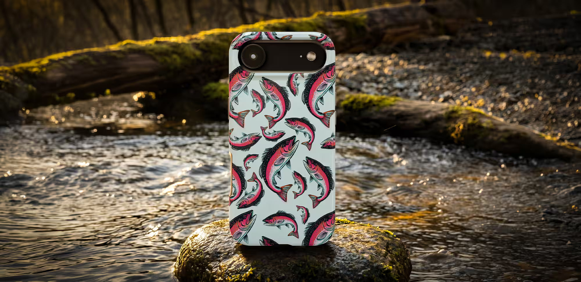Phone case with trout fishing pattern on a rock by a stream.