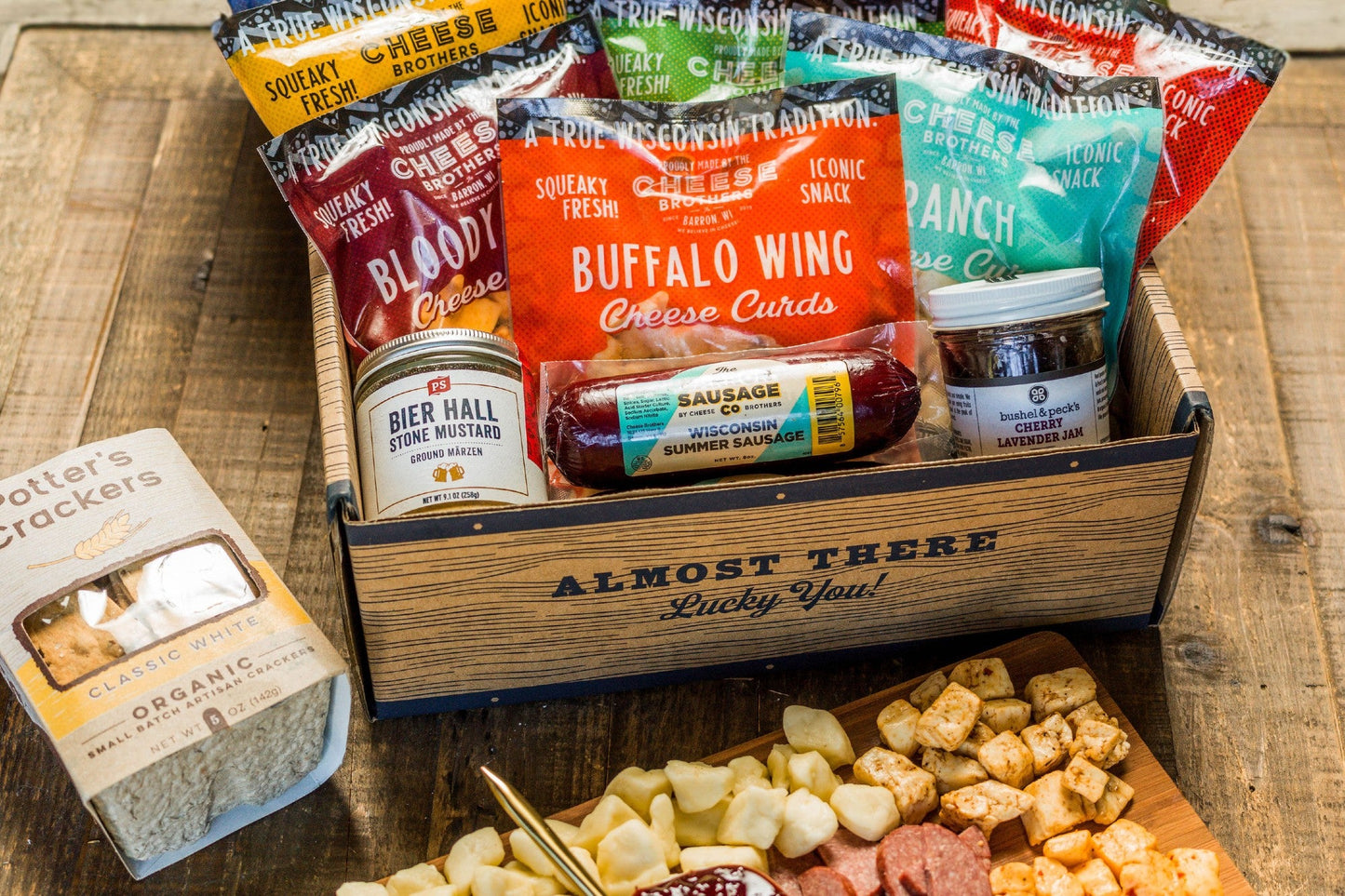 Wisconsin Cheese Curd and Summer Sausage Gift Box with Gourmet Jam, Mustard, and Organic Crackers curated by Kempain Family Outfitters.