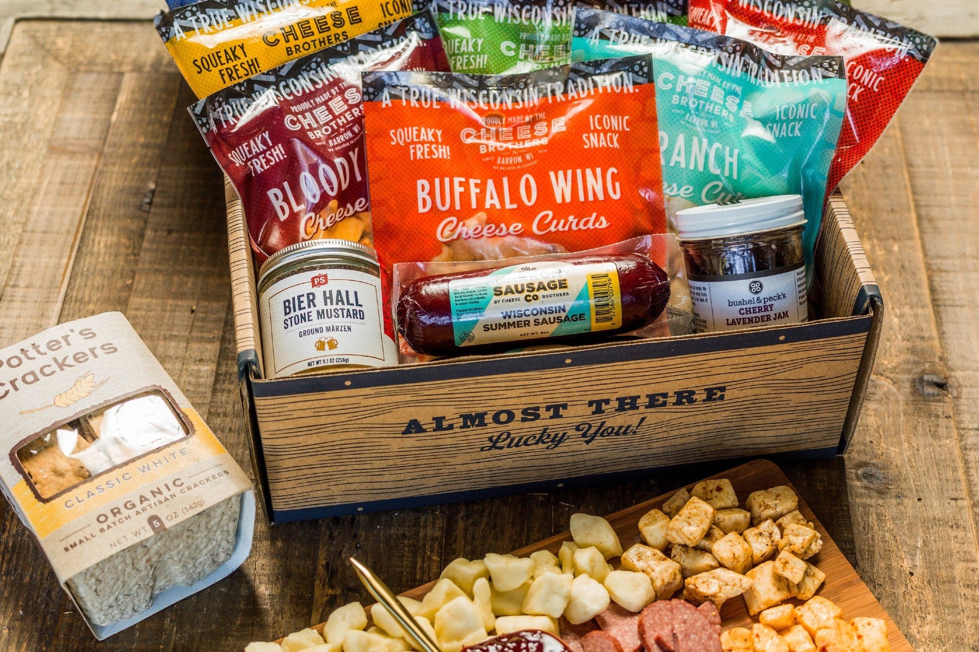 Wisconsin Cheese Curd and Summer Sausage Gift Box with Gourmet Jam, Mustard, and Organic Crackers curated by Kempain Family Outfitters.