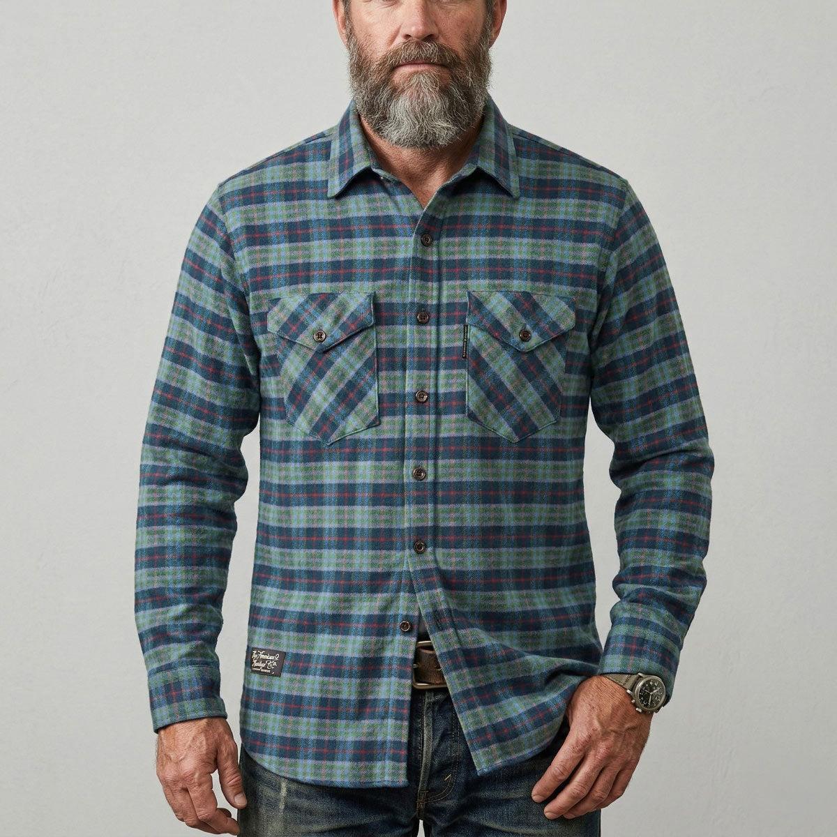 Men's Forest Green Plaid Vermont Flannel shirt on male model on a white background.