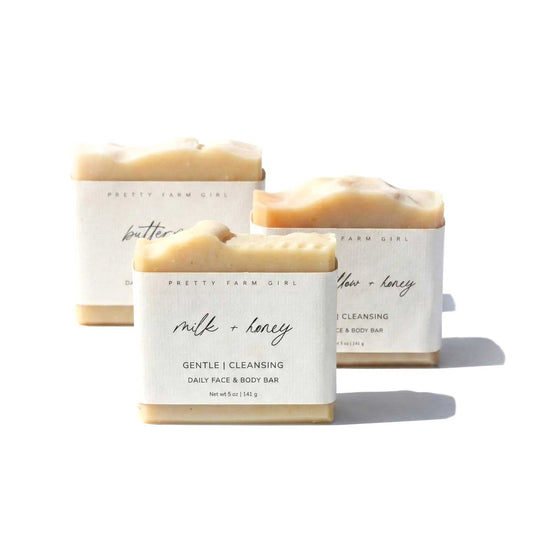 Three soap bars with visible labels on a white background. Handmade heritage ingredients like grass-fed tallow and farm-fresh milk.