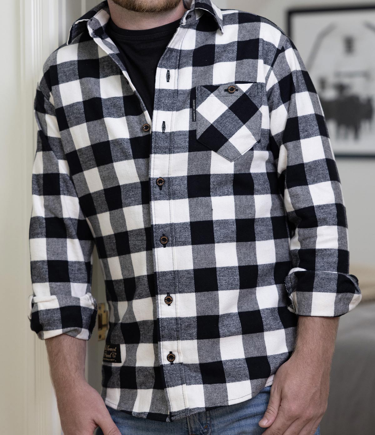 A man wearing a Fitted Black & White Checkered Organic Cotton Flannel Shirt.