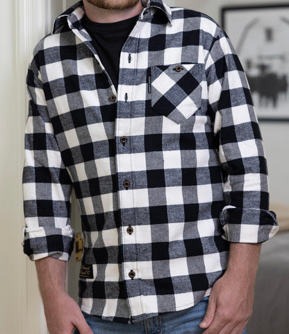 A man wearing a Fitted Black & White Checkered Organic Cotton Flannel Shirt.