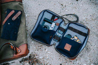 Full-Grain Leather Electronics / Toiletry Organizer displayed open with small camera and batteries.