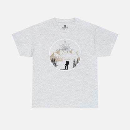 A ash color Unisex Cotton Tee on white background, featuring a captivating hand-drawn illustration that encapsulates the spirit of hiking. Featuring majestic mountains and a compass rising in the sky that beckons the call of adventure. 