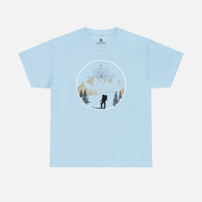 A light blue Unisex Cotton Tee on white background, featuring a captivating hand-drawn illustration that encapsulates the spirit of hiking. Featuring majestic mountains and a compass rising in the sky that beckons the call of adventure. 