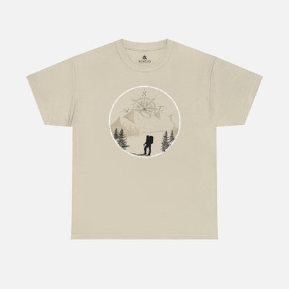 A sand color Unisex Cotton Tee on white background, featuring a captivating hand-drawn illustration that encapsulates the spirit of hiking. Featuring majestic mountains and a compass rising in the sky that beckons the call of adventure. 