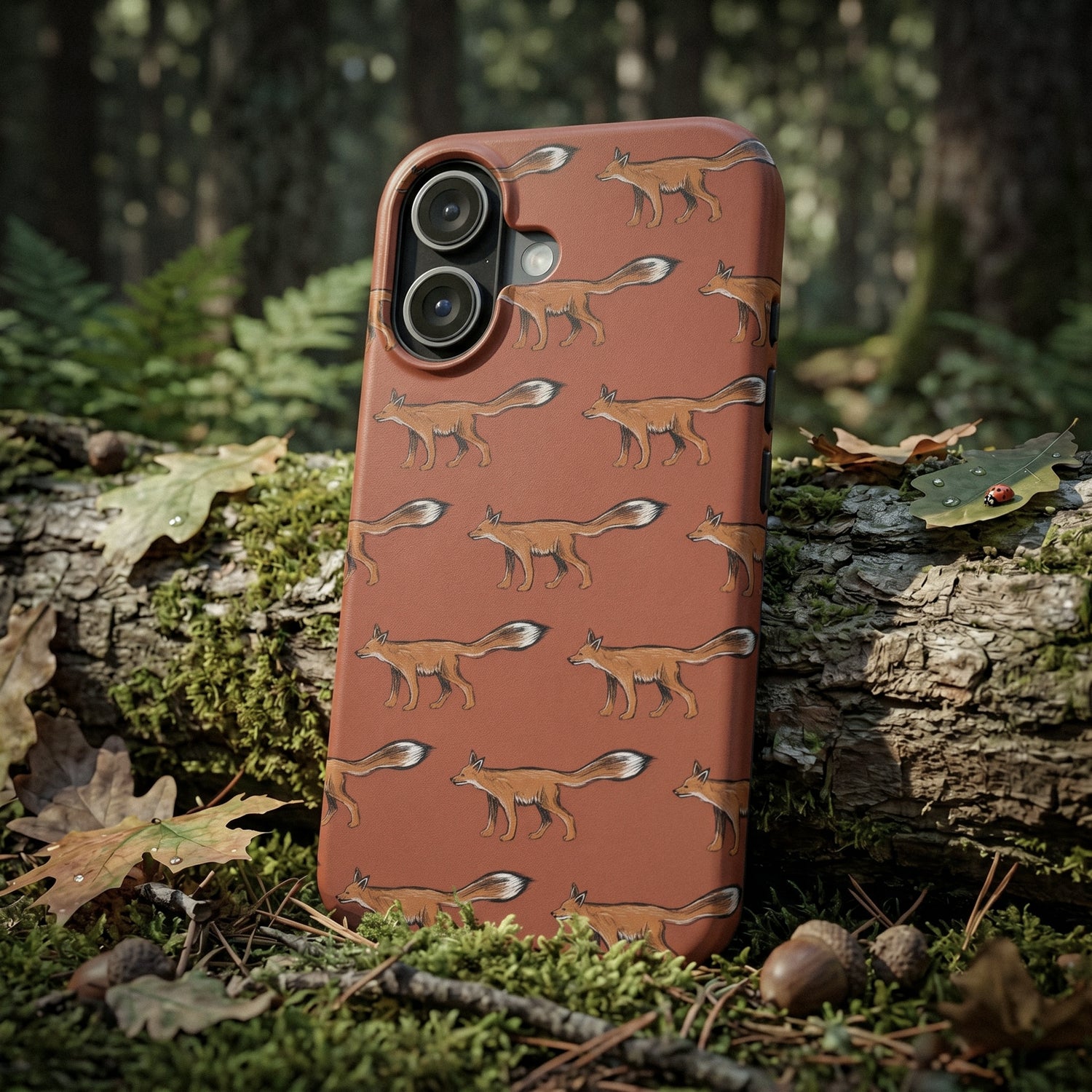 Phone case with illustrated fox pattern on a log in a forest setting by artist Jordan Kempain.