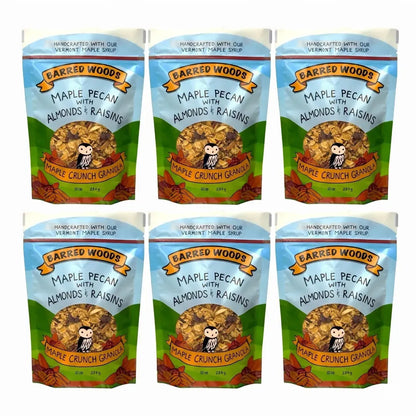 Six packages of Barred Woods Maple Crunch Granola with Pecans, Almonds, and Raisins on a white background.