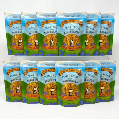 12 packages of Barred Woods Maple Pecan with Blueberries Crunch Granola on a white background