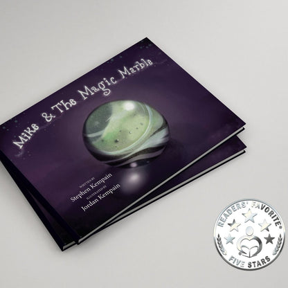 Book titled 'Mike & The Magic Marble' with a green marble on a purple cover, on a white background.