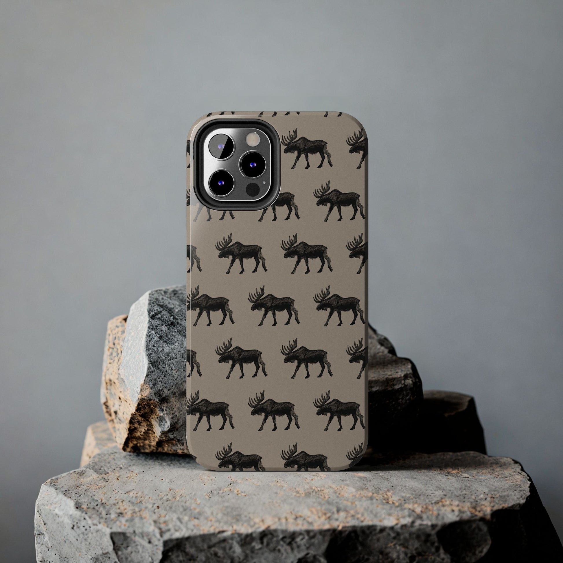 iPhone on a rock featuring a moose pattern protective case. Perfect for those who love the outdoors and moose country. 