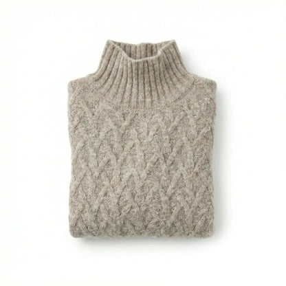 Oat alpaca wool sweater featuring a lattice cable knit pattern and mock neck design on a white background.