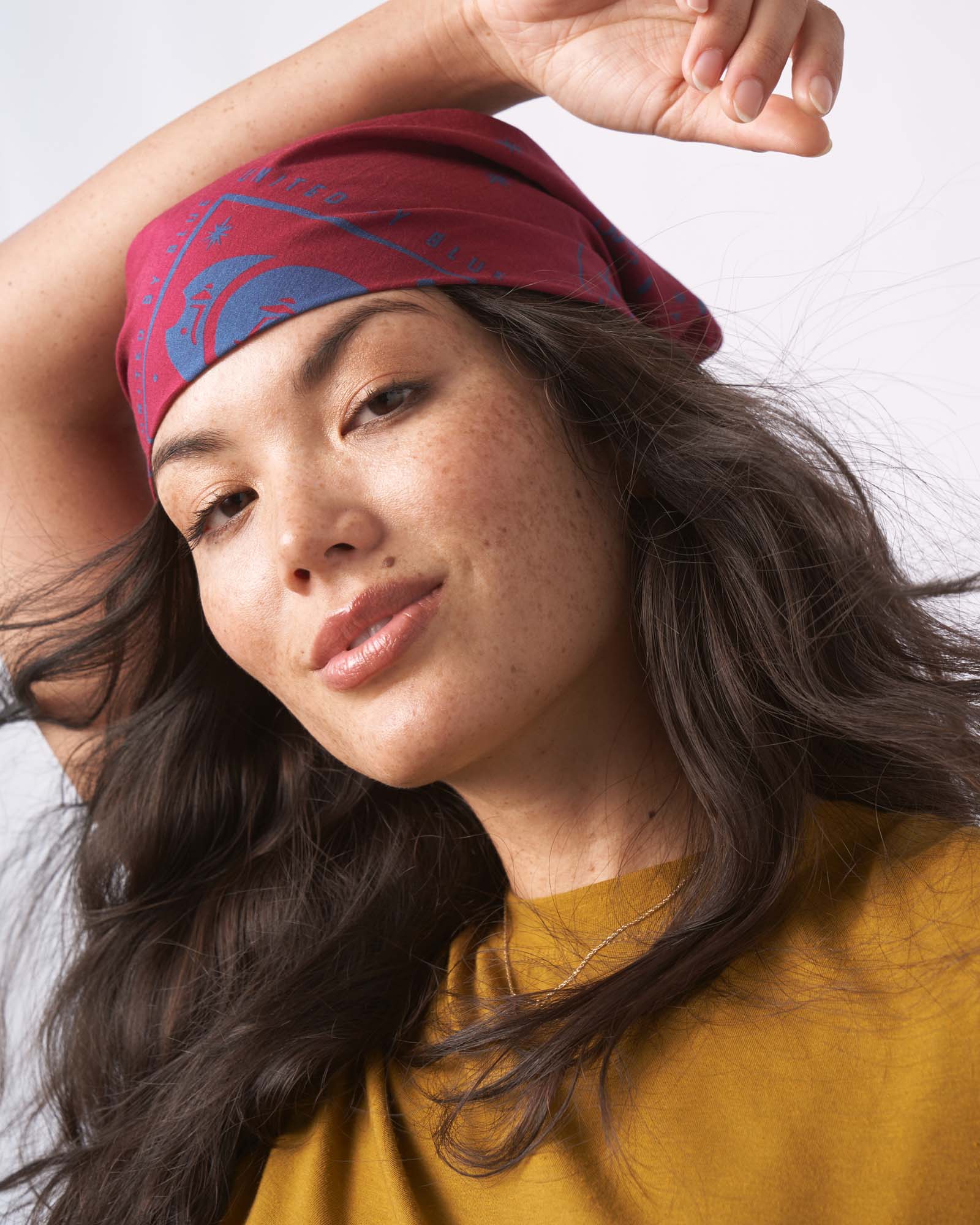 Red "Beet" color Organic Cotton Bandana from United By Blue displayed on a female model.