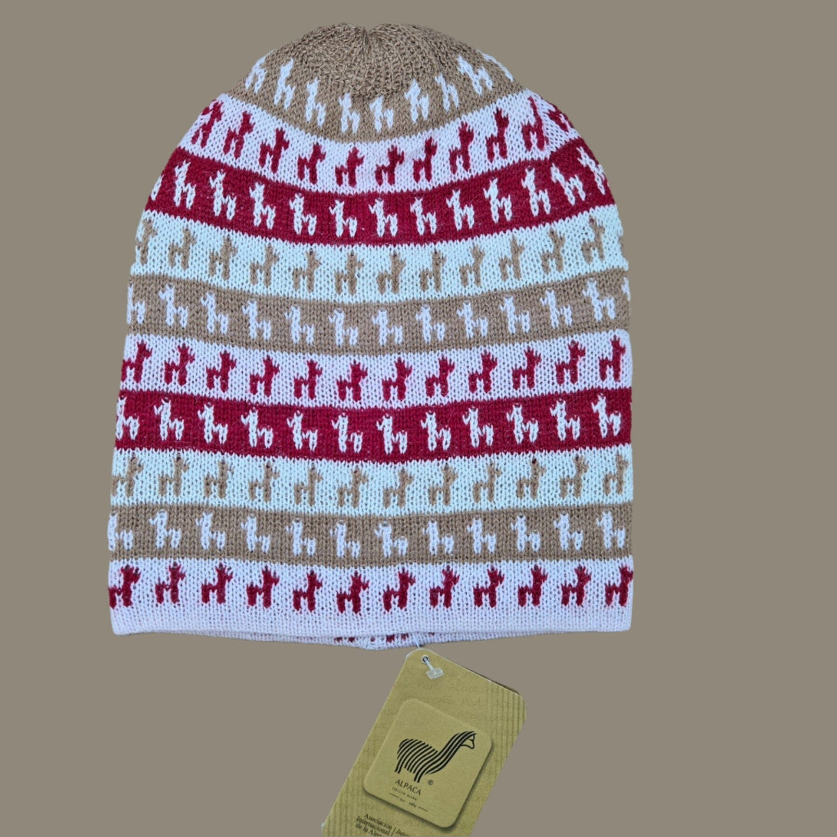 Red and brown Knitted hat with Alpaca pattern on a beige background