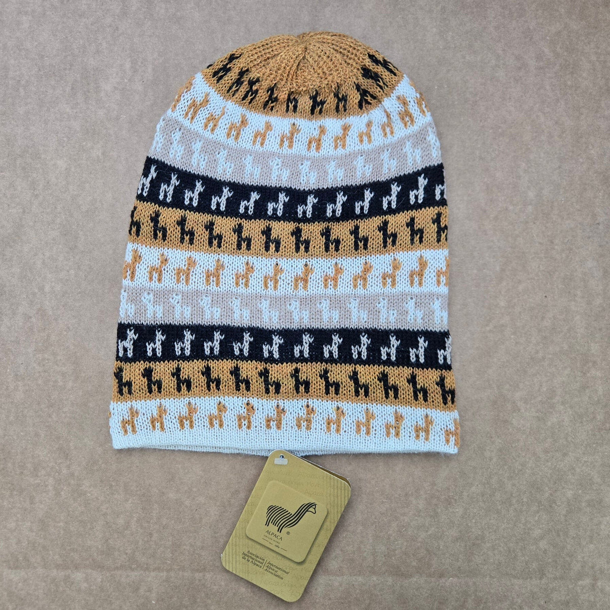 Gold color knitted Alpaca hat with Alpaca pattern on a brown background
