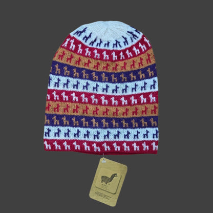 A multicolor knit beanie hat with horizontal stripes of Alpaca silhouettes in navy, red, tan, and light blue, shown with a tan paper tag below on a white background.