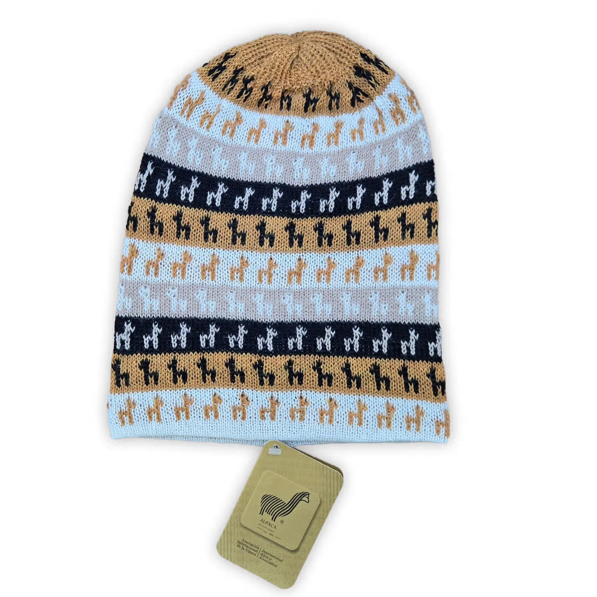 A knitted beanie hat with horizontal stripes of light blue, gray, black, and tan, featuring a repeating llama pattern. A matching tan hangtag with a Alpaca logo is placed below the hat on a white background.