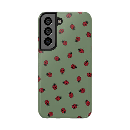 Phone case with ladybug pattern on a green background