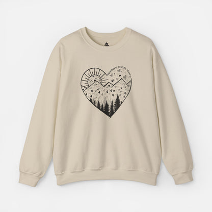 A sand color crewneck sweatshirt featuring a heart-shaped mountain design with the text and Mountains Inspire Hearts, perfect for anyone that loves hiking, mountain views, or the outdoors.