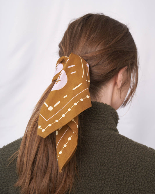 Smoky Ochre Organic Cotton Bandana from United By Blue displayed on female model.