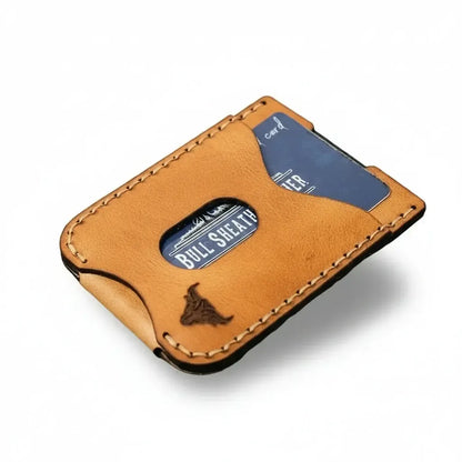 Brown leather wallet with blue card on a wooden surface