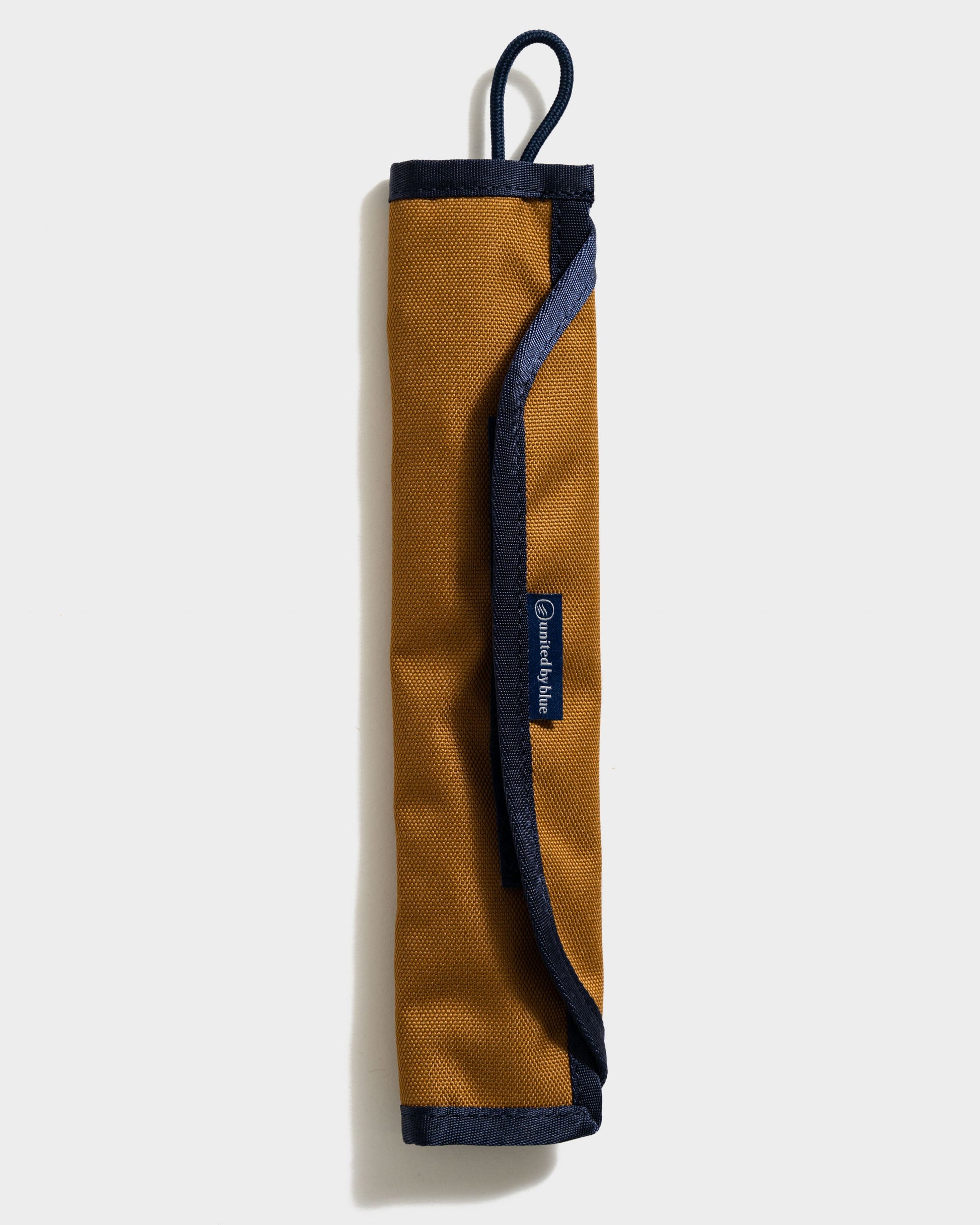 The Straw Kit in Camel from United By Blue displayed on a white background folded.