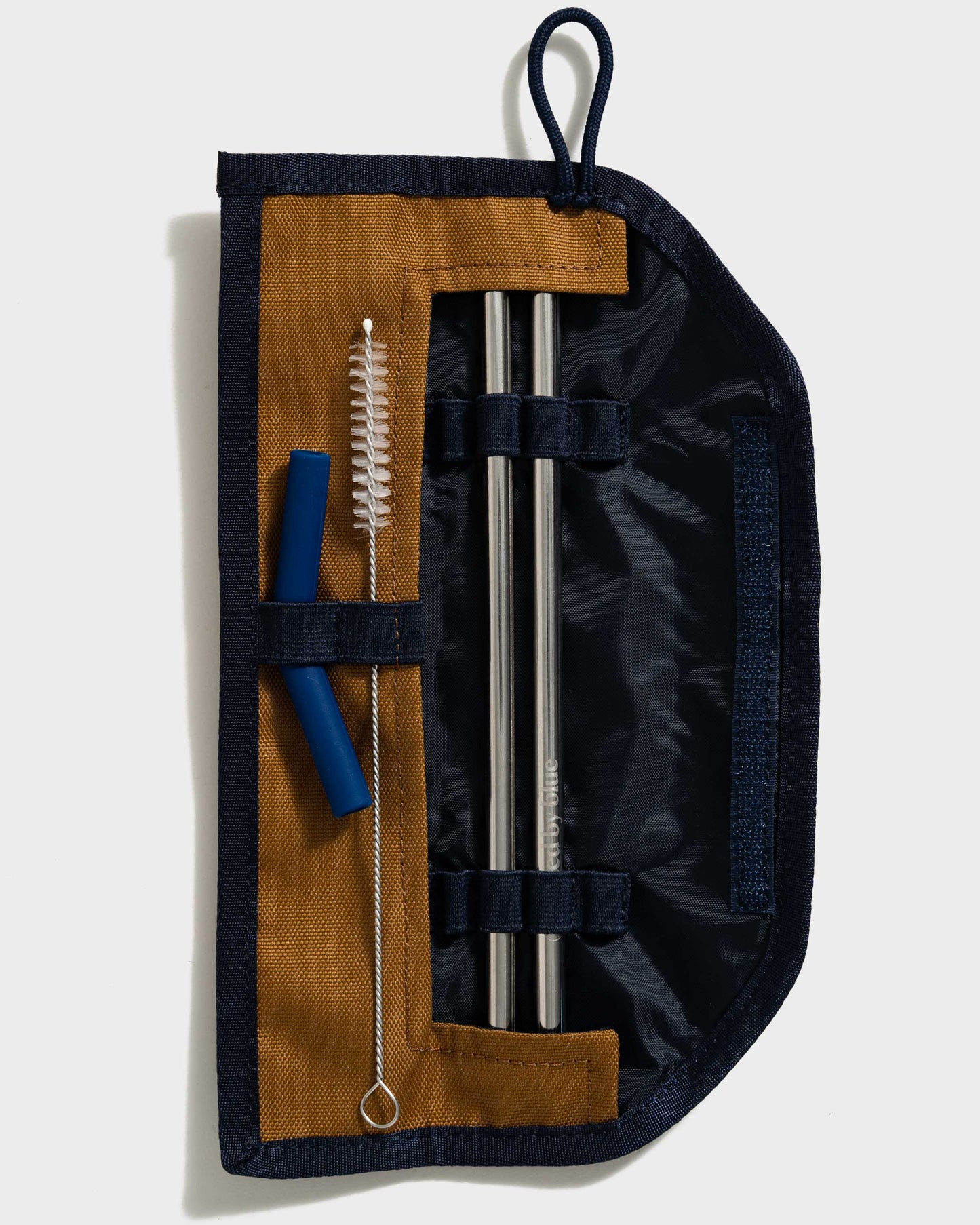 The Straw Kit from United By Blue Camel displayed on a white background open showing straws and cleaner brush.