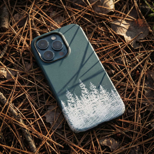 Phone case with forest timber line design on a bed of pine needles