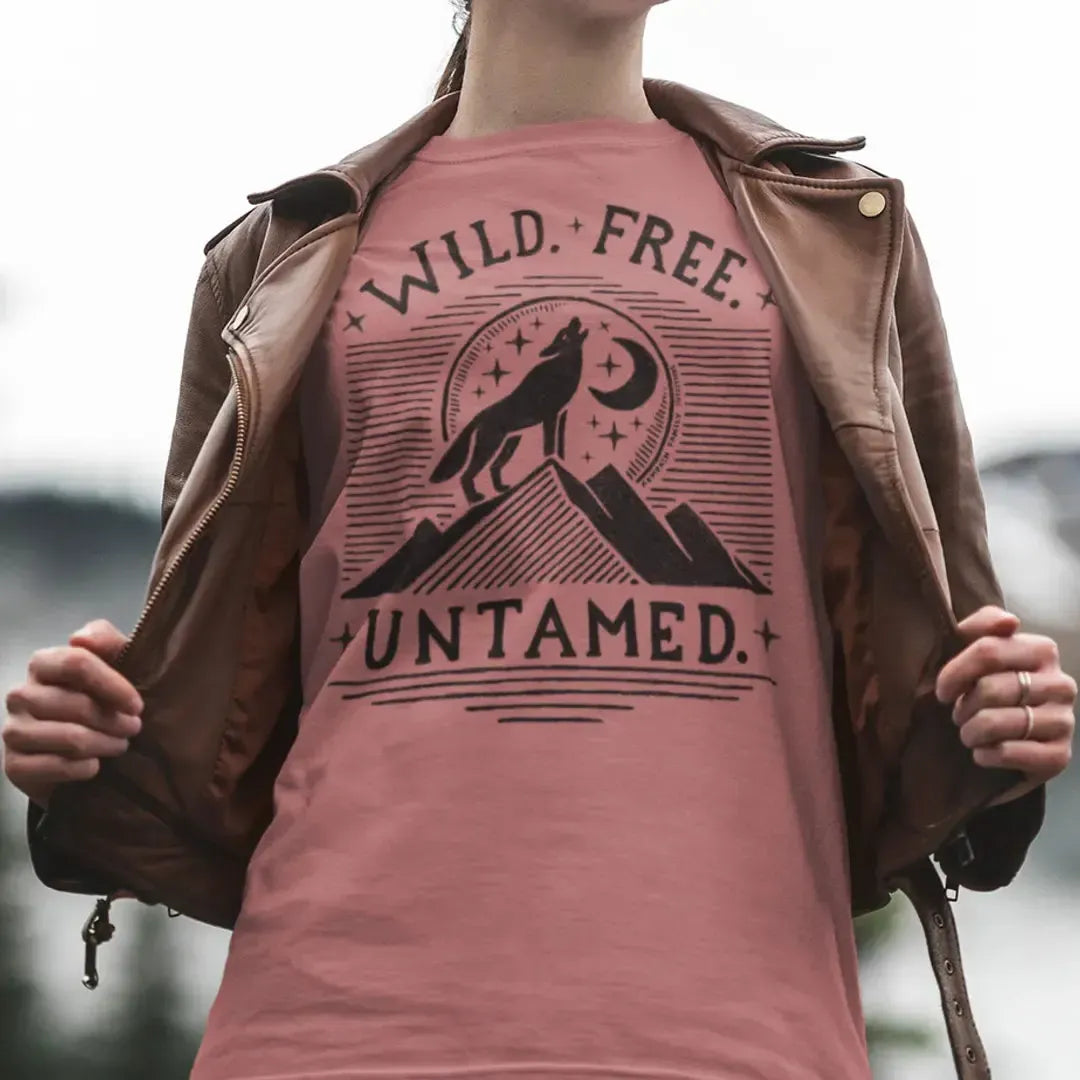 The Untamed Wolf 100 percent cotton Women’s T-Shirt worn by a female model featuring artwork illustrated by Jordan Kempain, available in sizes Small through 5XL.