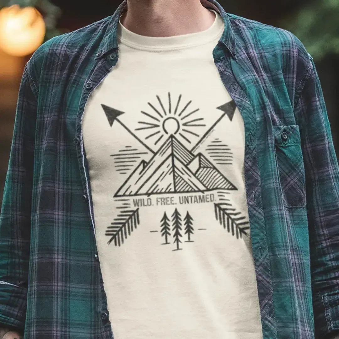Model wearing Wild. Free. Untamed. Adventure-Inspired Unisex T-Shirt, featuring bold typography, perfect for adventurers, explorers, and outdoor enthusiasts.