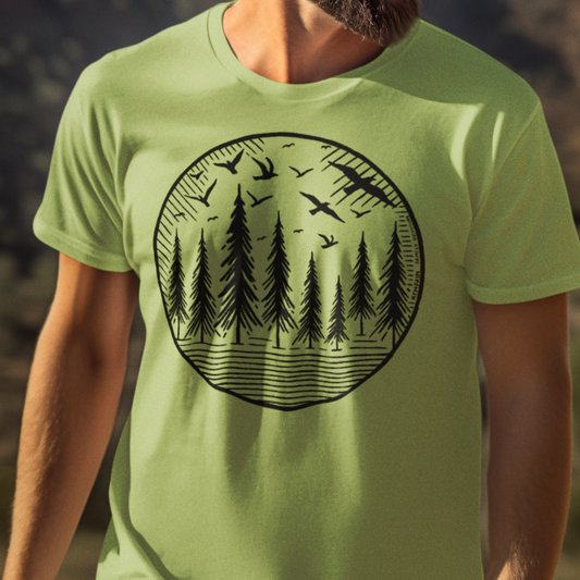 Model wearing Wildwood Flight T-Shirt, featuring a hand-drawn geometric design of soaring birds and towering pine trees, perfect for nature lovers and outdoor explorers.
