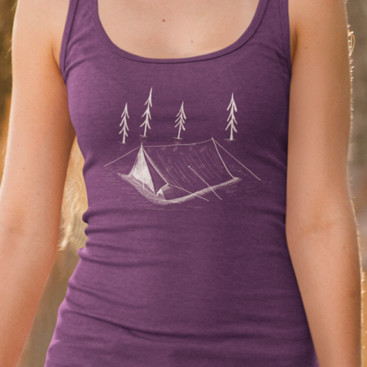 A purple women's racerback tank top on model featuring a tent and trees. Perfect for women who enjoy camping trips and ruffing it in the wild. 