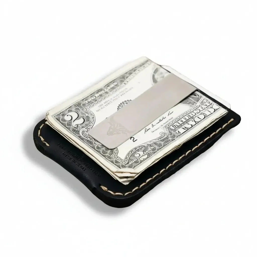 Black leather wallet with dollar bills on a wooden surface