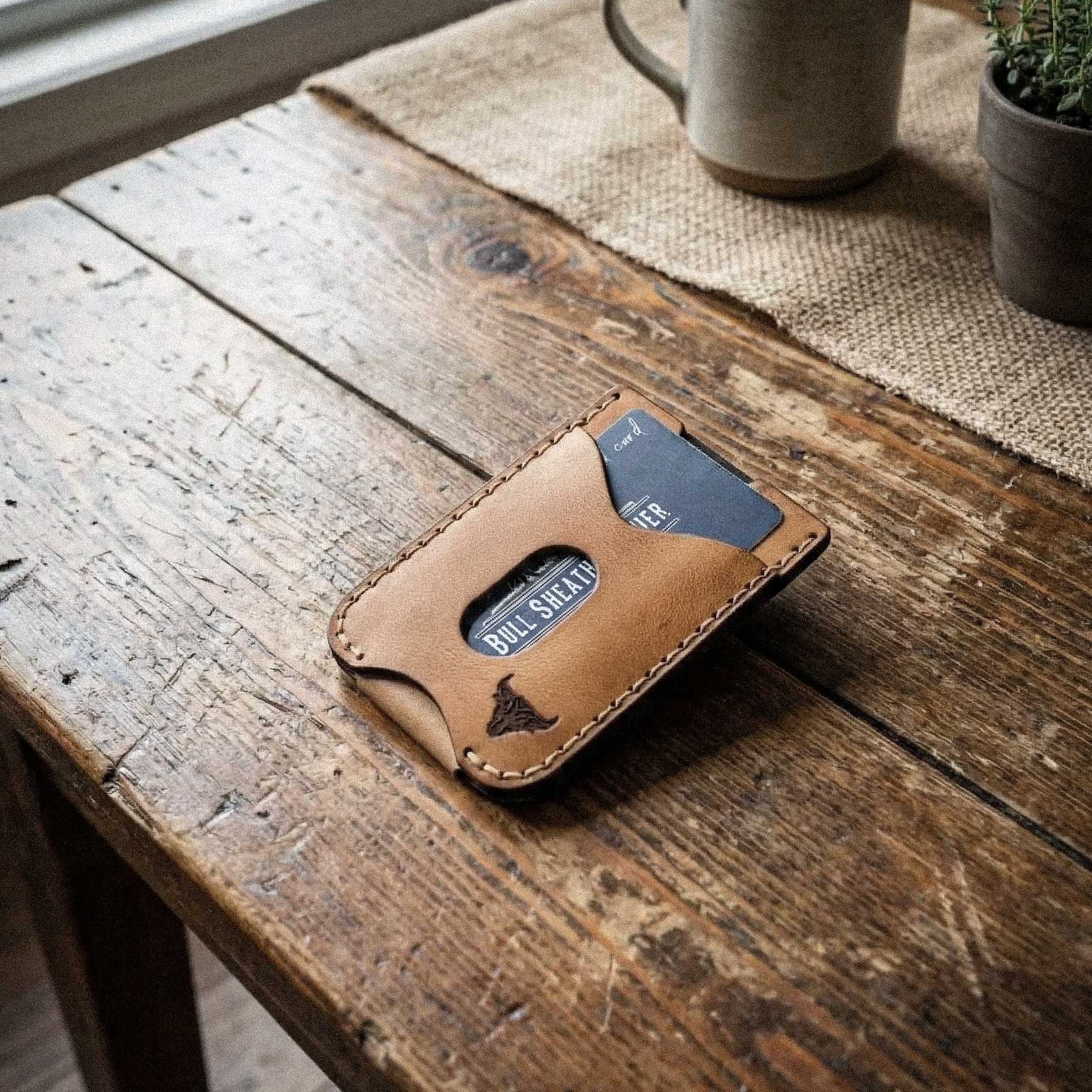Brown leather wallet with cards on a wooden surface