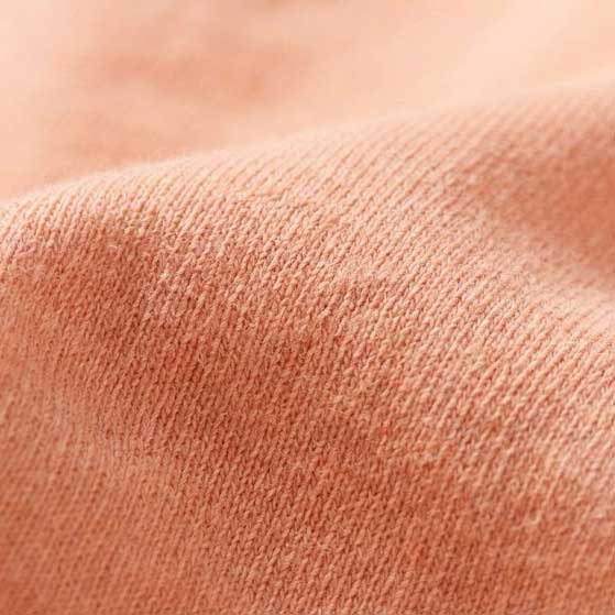 Close-up texture of the 6.4 oz Comfort Colors 1466 Peachy garment-dyed cotton, highlighting the soft-washed, natural fiber grain.