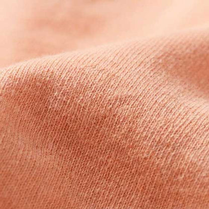 Close-up texture of the 6.4 oz Comfort Colors 1466 Peachy garment-dyed cotton, highlighting the soft-washed, natural fiber grain.