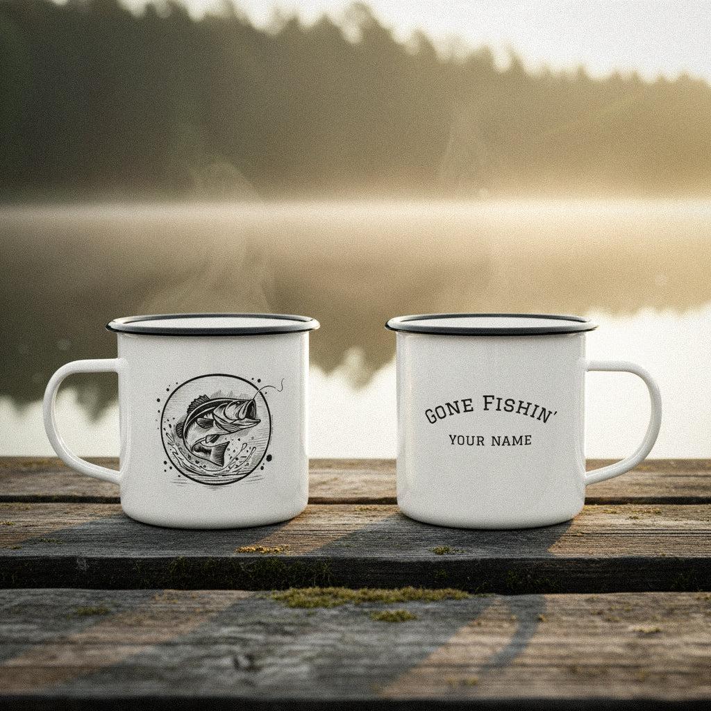 Two personalized bass fishing mugs on a rustic wooden dock by a misty lake at sunrise.