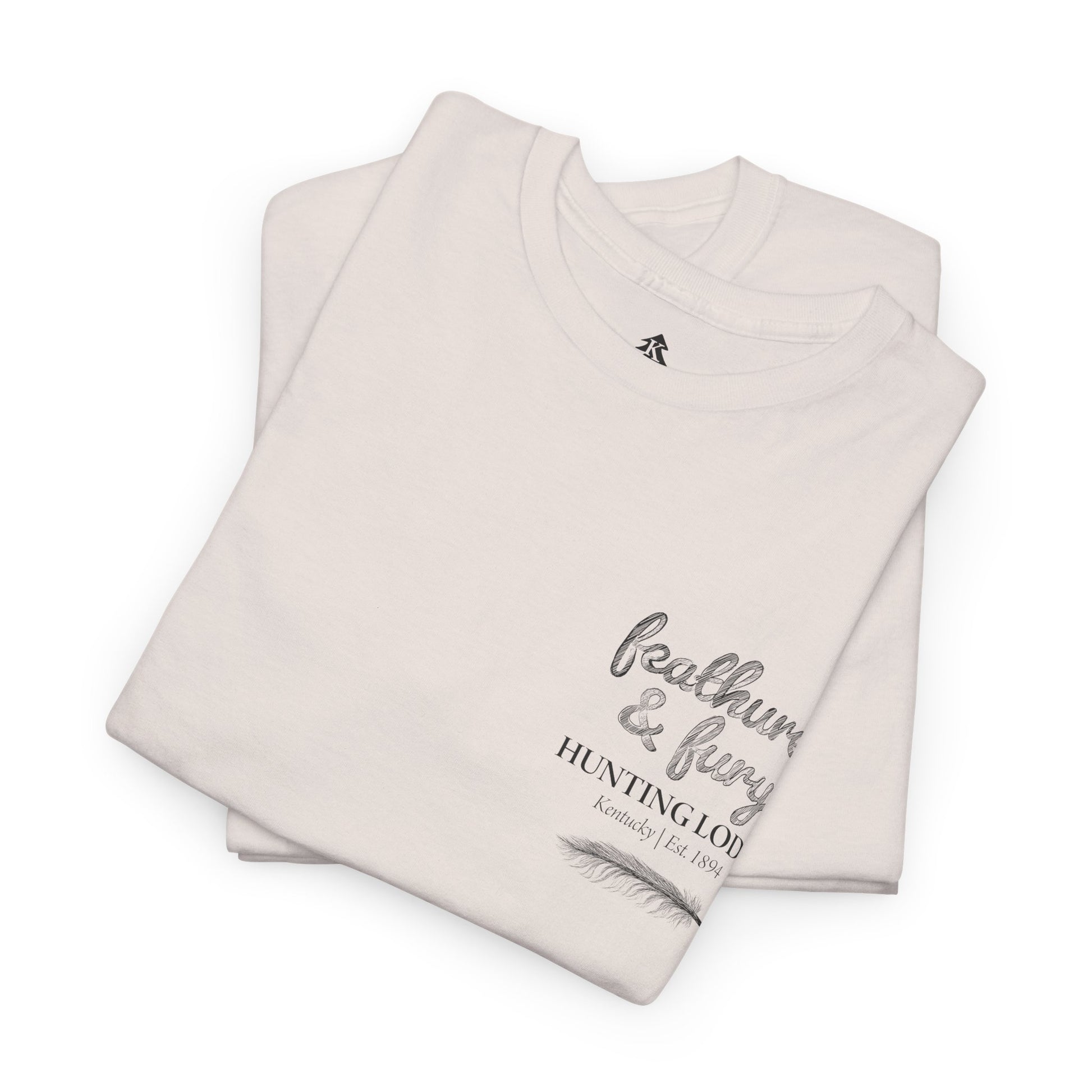 Folded Feathers & Fury Hunting Lodge Tee on a white background, highlighting its comfortable fabric and detailed turkey hunting graphic.